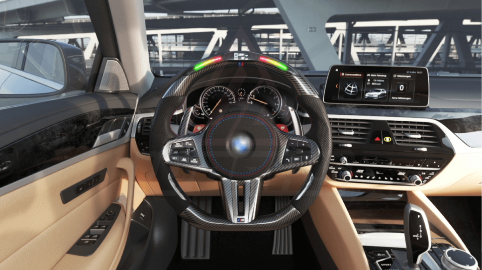 Front view of a BMW G/F chassis, M steering wheel in carbon fiber, black perforated leather, driving assistant pro buttons, m color accents and led shift lights